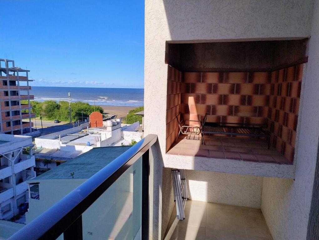 a balcony with a brick oven on the side of a building at Apartment 1 block from the sea in Mar de Ajó