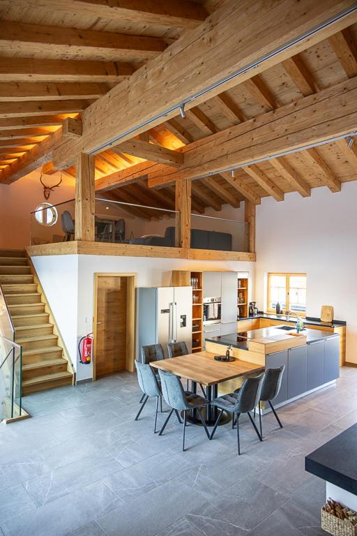 a kitchen and dining room with a table and chairs at Chalet Zaferna in Mittelberg