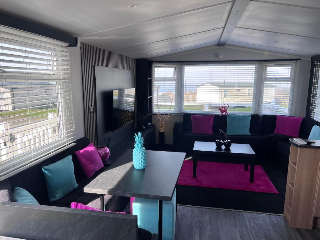 a living room with a couch and a table at 107 Arran View with WiFi in Ayr