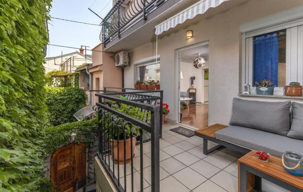 a balcony with a couch and a window at KARLA in Selce
