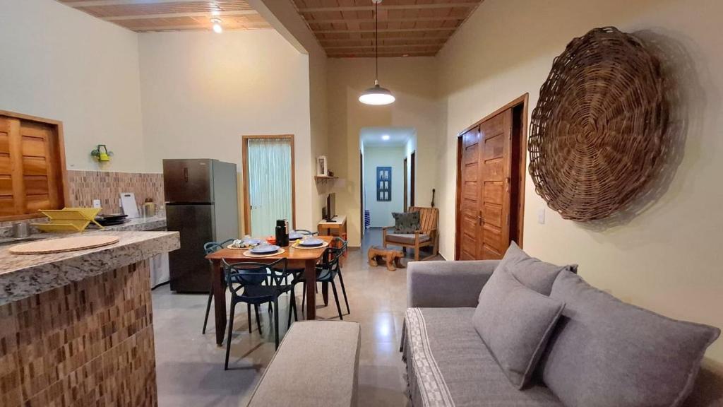 a kitchen and living room with a couch and a table at Casa do Brother in Prado