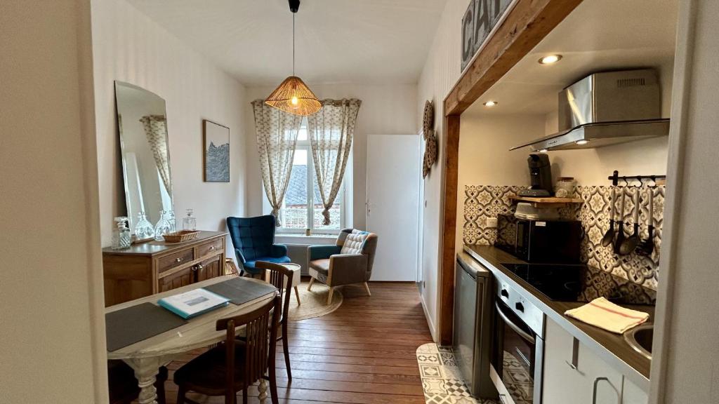 a kitchen with a table and a dining room at Belle échappée in Le Crotoy