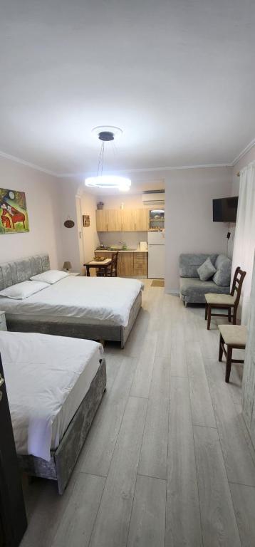 a bedroom with two beds and a living room at ERLA'S apartment in Tirana