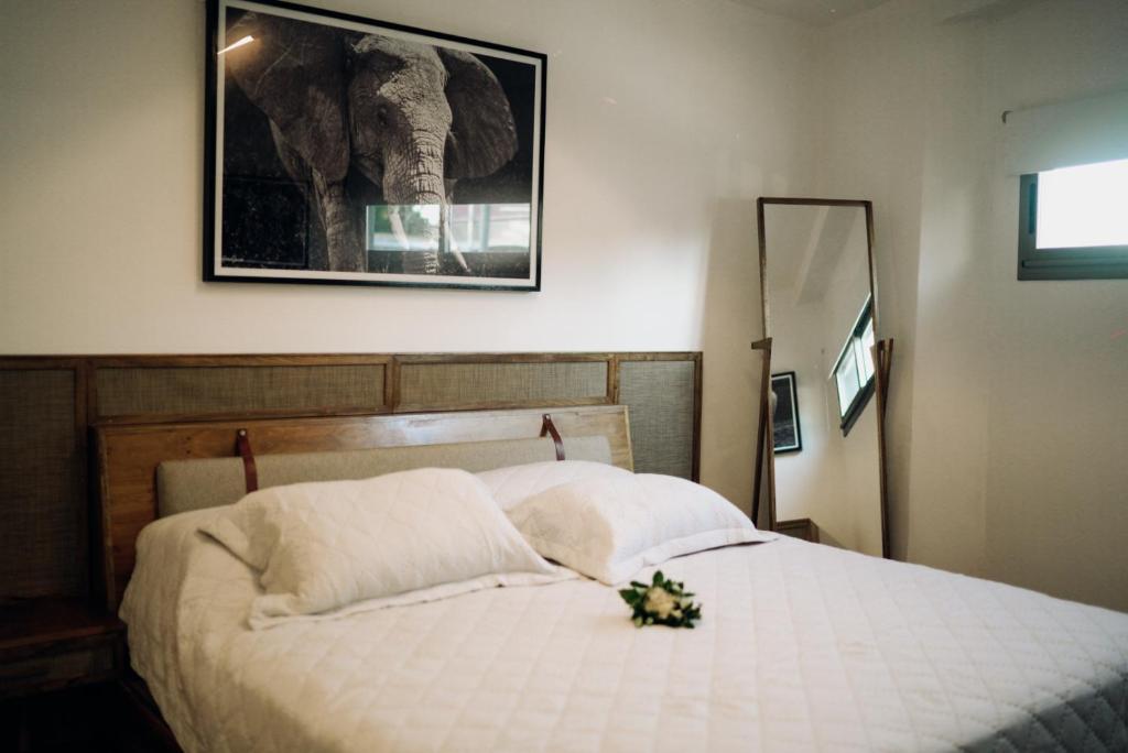 a bedroom with a bed with a flower bouquet on it at DePhazz I Wellness Clinic & Spa in Junín