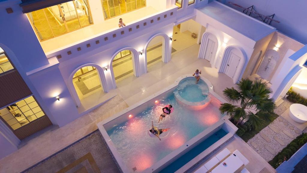 an overhead view of a swimming pool in a house at Brown Empire Pool Villa Pattaya in Nong Prue