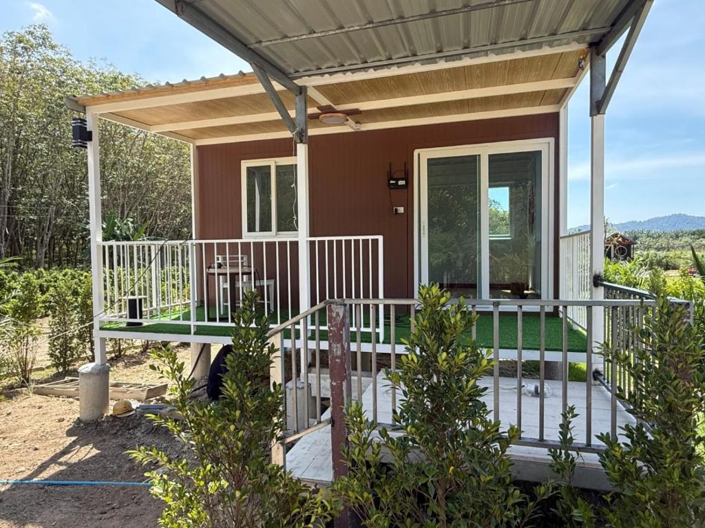 a small house with a porch and a deck at Nordic Mountain View in Ban Khlong Chi Lat