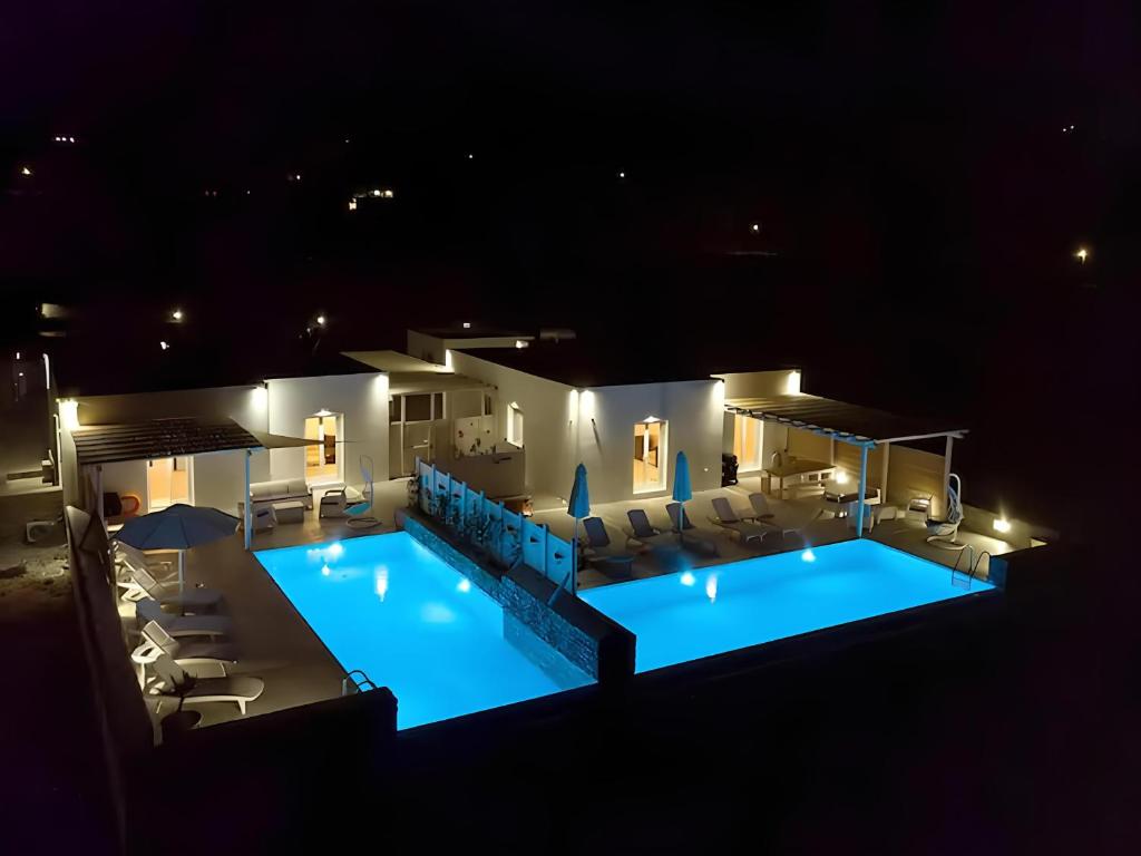 an overhead view of a swimming pool at night at Cycladic Breeze Villas in Kampos Paros