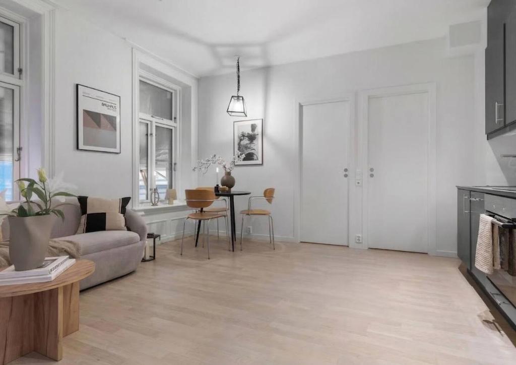 a living room with a couch and a table at Prime Central Oslo - Frogner, All-Inclusive Apartment in Oslo