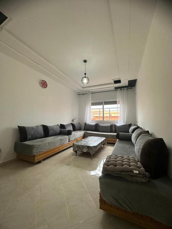 a large living room with couches and a table at appartement confortable in Berkane