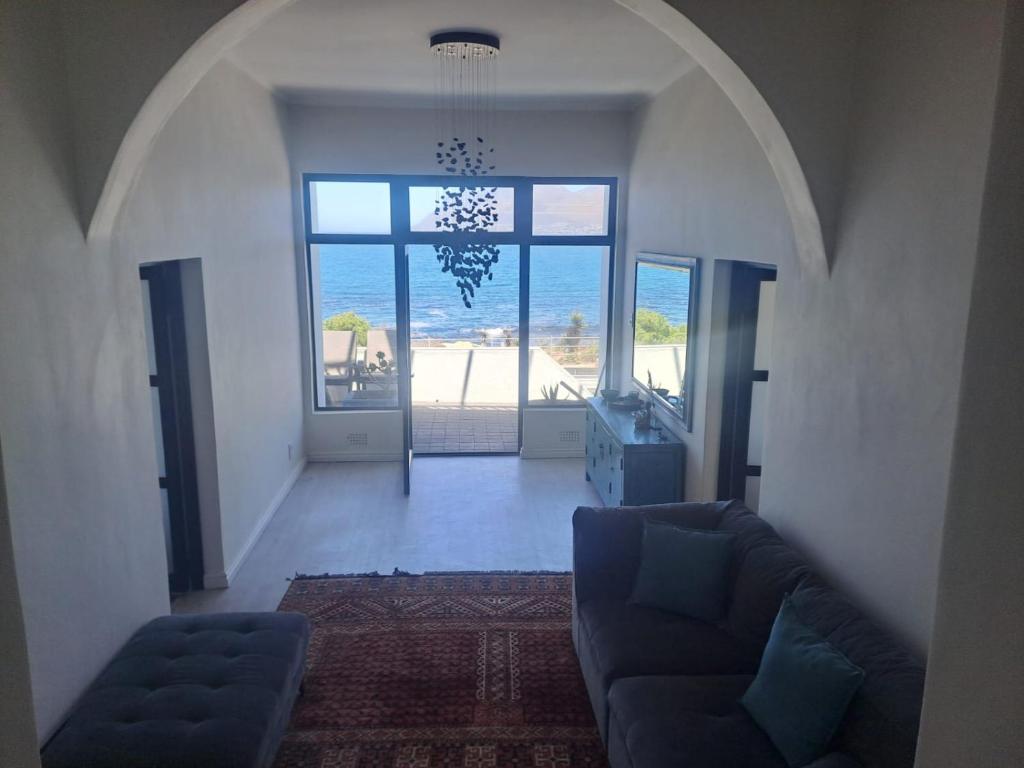 a living room with a couch and a view of the ocean at 210 on Main in Kalk Bay