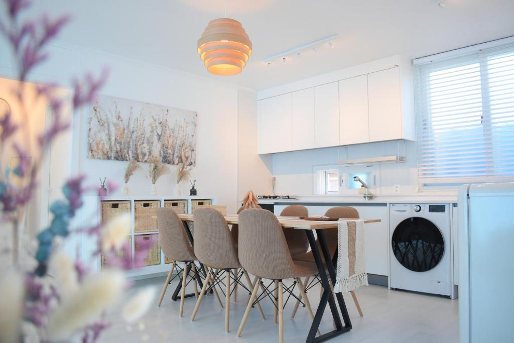 a kitchen with a table and chairs in it at RoseBrickHouse in Gwangju