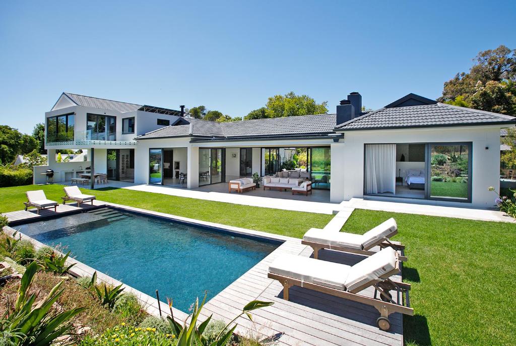 a house with a swimming pool in the yard at Table Mountain and Constantiaberg view in Sweet Valley