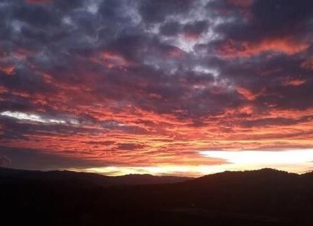 a sunset with the sun setting in the sky at Eco-Loft Ixtapan de la Sal in Ixtapan de la Sal