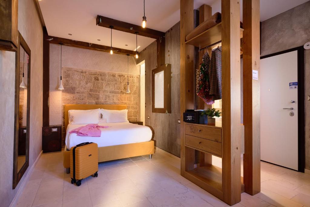 a bedroom with a bed and a wooden wall at Mamaco Trani Homey in Trani