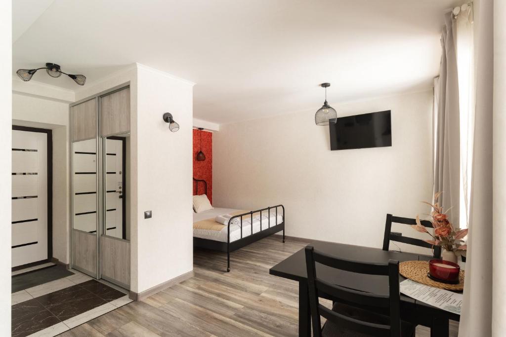 a small apartment with a dining room and a bedroom at Park-View Studio Apartment with Free Parking - 10 min to Old Town in Riga
