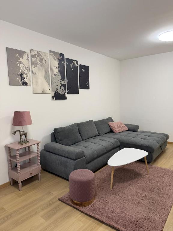 a living room with a couch and a table at Moderne zentrale Wohnung in Grosspetersdorf