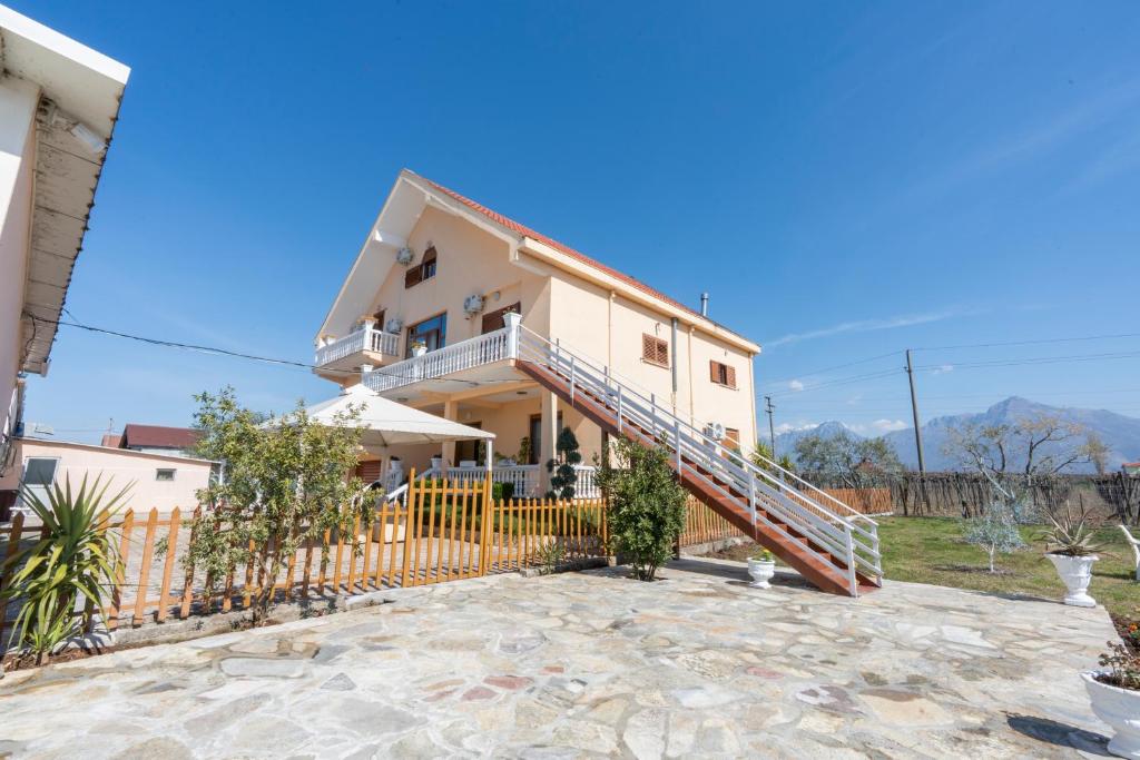 a house with a staircase in front of it at Guesthouse 3 Diamonds in Omarë