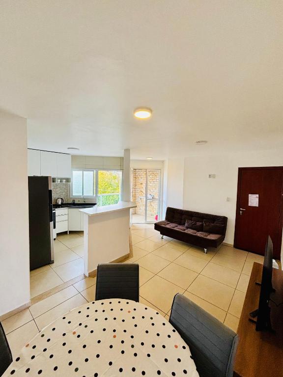 a living room with a couch and a table at Apto Rio grande com varanda e 160mt de terraço in Rio Grande