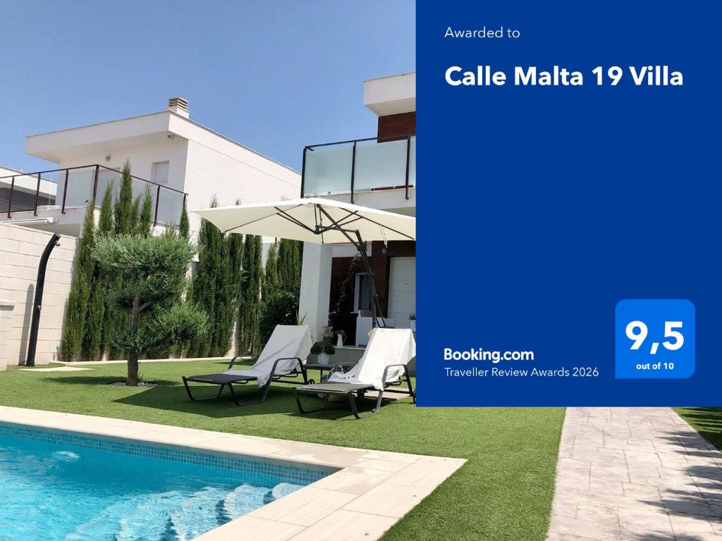 a villa with a swimming pool and two chairs and an umbrella at Calle Malta 19 Villa in Santa Pola