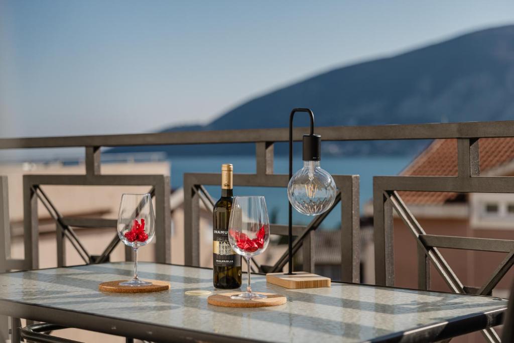 a table with two bottles of wine and two glasses at Sea Point Apartments Igalo in Igalo