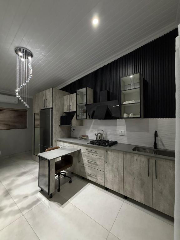 a kitchen with a table and a counter top at Divine2 Elegant Luxury suite in Bloemfontein