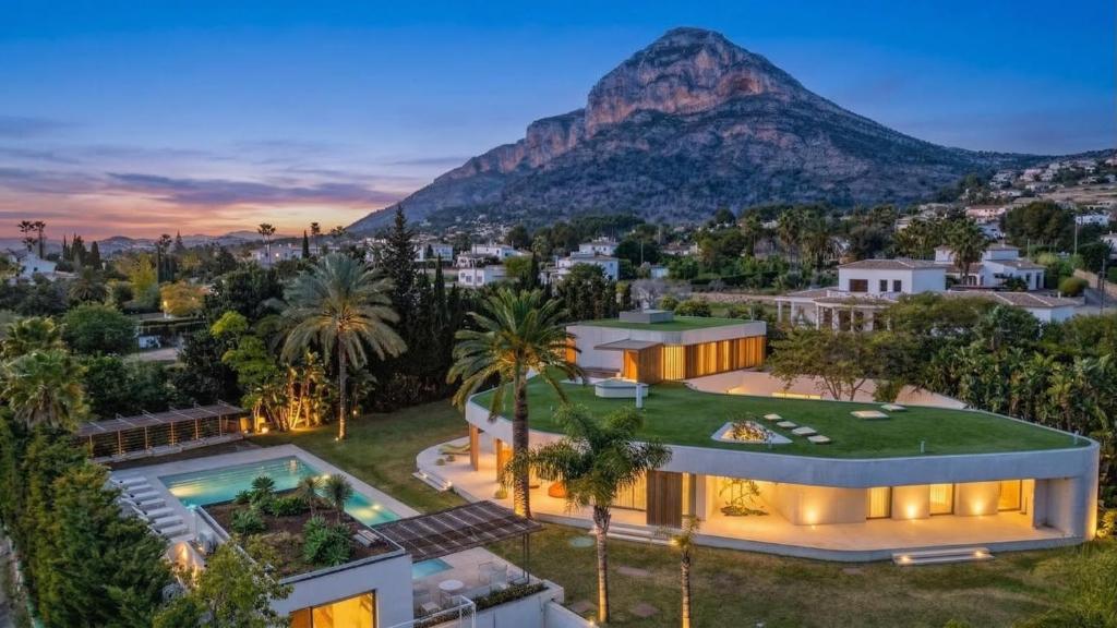 an aerial view of a house with a mountain in the background at Casa Torus Luxury Design Villa with Private SPA & Cinema in Jávea