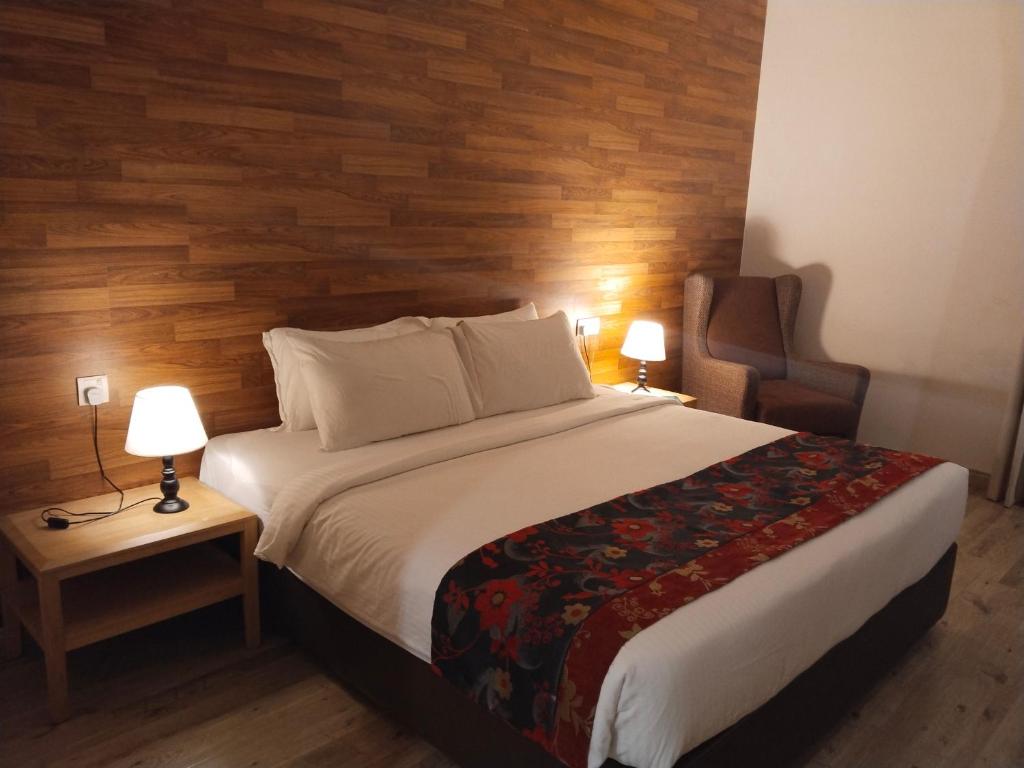 a bedroom with a bed with a wooden wall at park view Service Apartment near KLCC in Kuala Lumpur