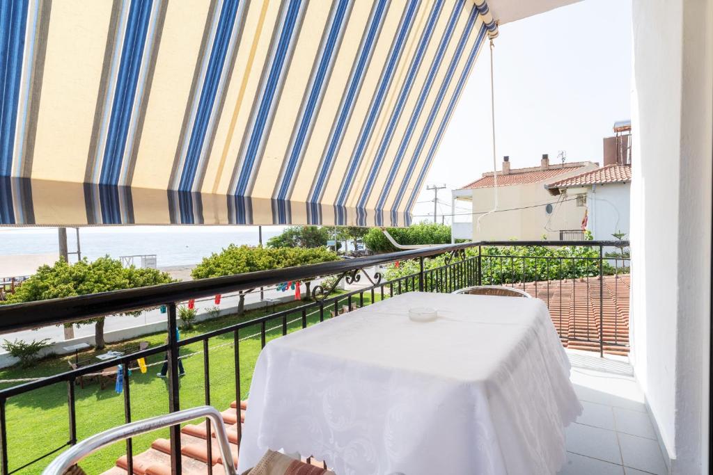 a table on a balcony with a view of the ocean at Workation Studio by the Sea in Velika