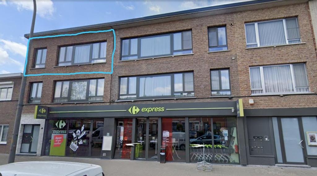 a large brick building with a car parked in front of it at Mazzity 2 in Antwerp