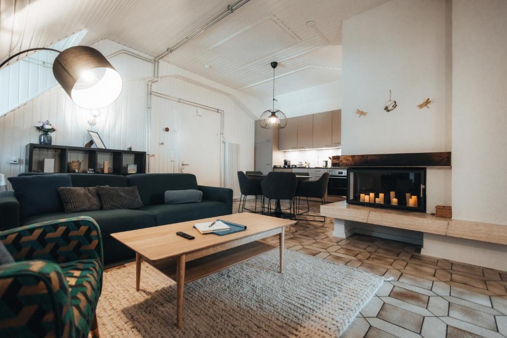 a living room with a couch and a fireplace at LaVida LakeSoul Cozy Retreat in Murten am See & Altstadt, free parking in Murten