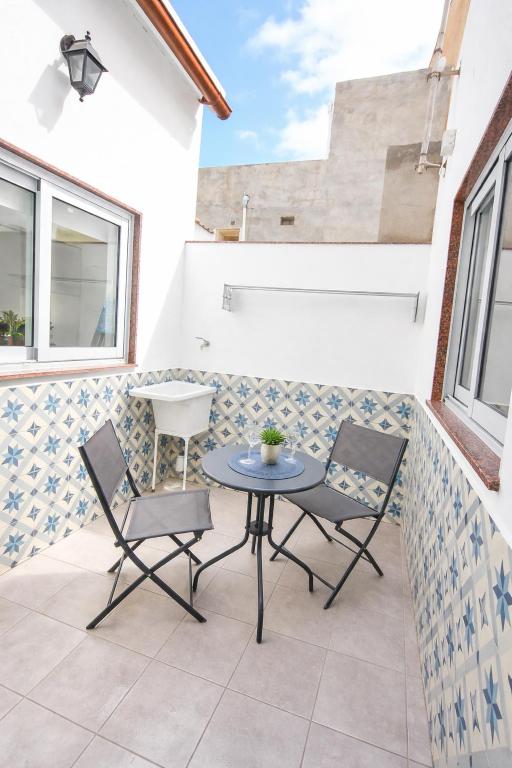 a patio with two chairs and a table at Casa Ángela in La Restinga