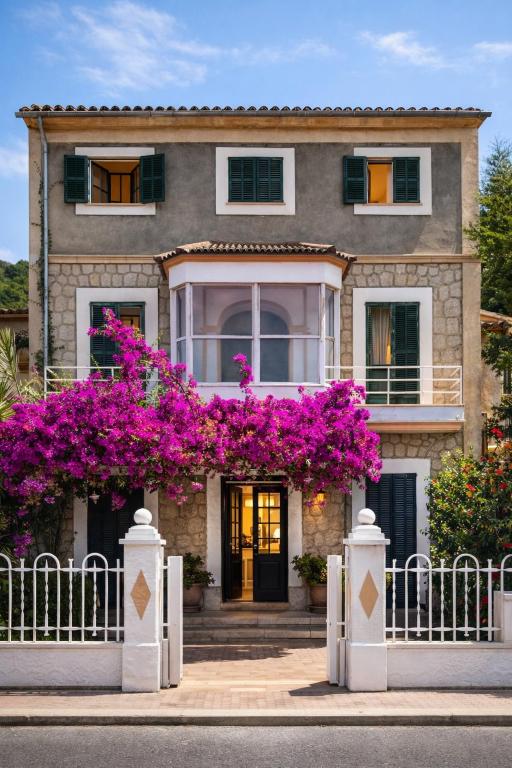 a house with purple flowers in front of it at Primavera House Port Sóller formerly Sol Port Sóller in Port de Soller
