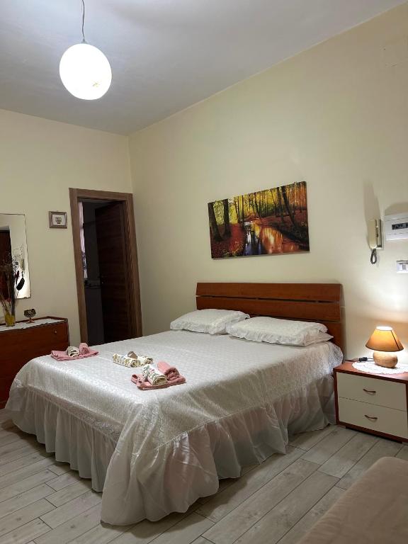 a bedroom with a large bed with a white bedspread at IL PARADISO DEGLI DEI 2 in Agerola