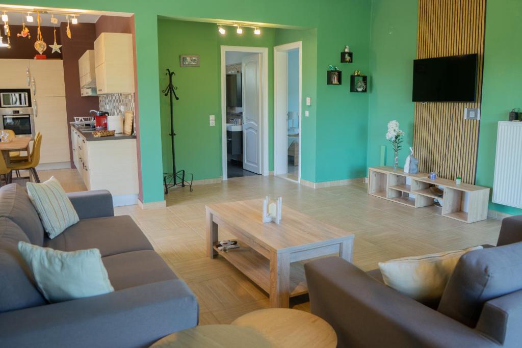 a living room with two couches and a coffee table at Alex house in Kouramaditika
