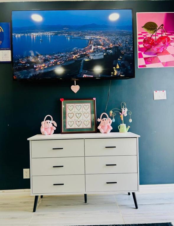 a room with a dresser with a tv on the wall at Fancy Studio Private Entrance in Selden