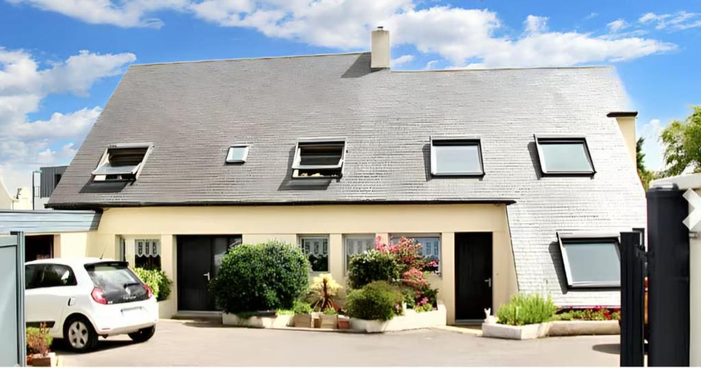 a white car parked in front of a house at Ty arvor in Saint-Pol-de-Léon