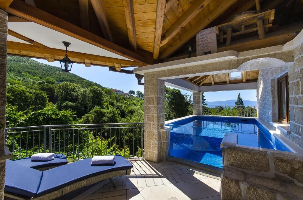 a villa with a swimming pool on a patio at Villa Strnj in Živogošće