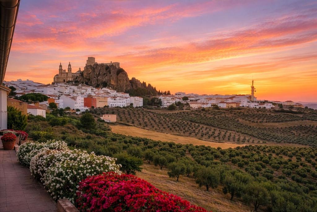 a view of a city with a mountain and flowers at Villa Campanilla in Olvera