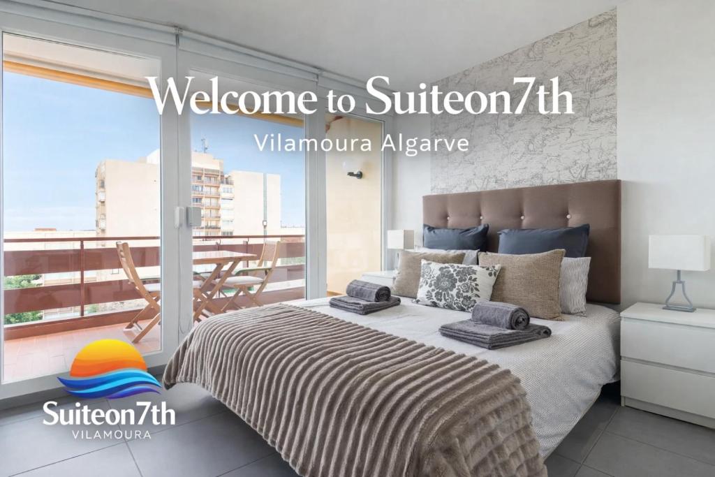 a bedroom with a large bed with a balcony at SuiteOn7th Vilamoura Panoramic Sunset View Balcony Suite in Quarteira