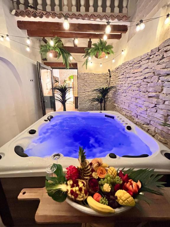 a large jacuzzi tub with a plate of food in front at Fuera de tiempo in Albalat de la Ribera