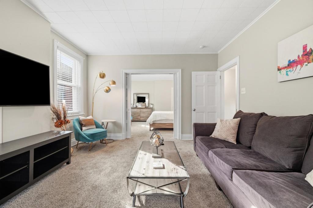a living room with a couch and a tv at Spacious & Clean 3BR 2 Balconies Parking in Pittsburgh