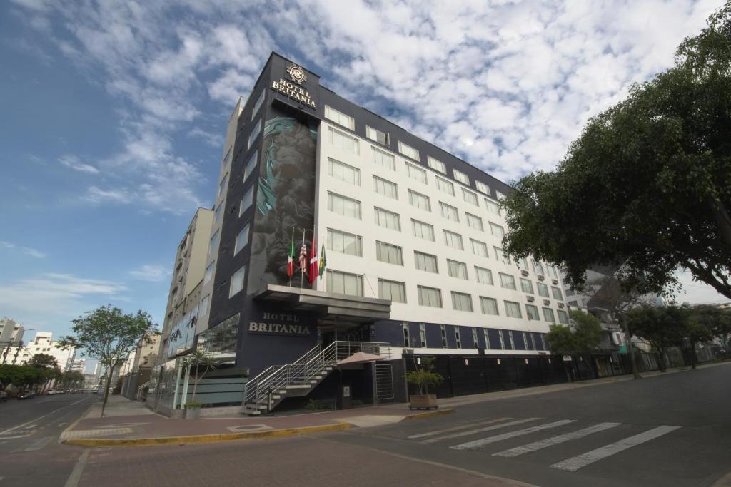 a white building with a mural on the side of it at Hotel Britania Miraflores in Lima