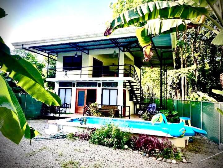 a house with a swimming pool in front of it at Playa Negra Art House in Hone Creek