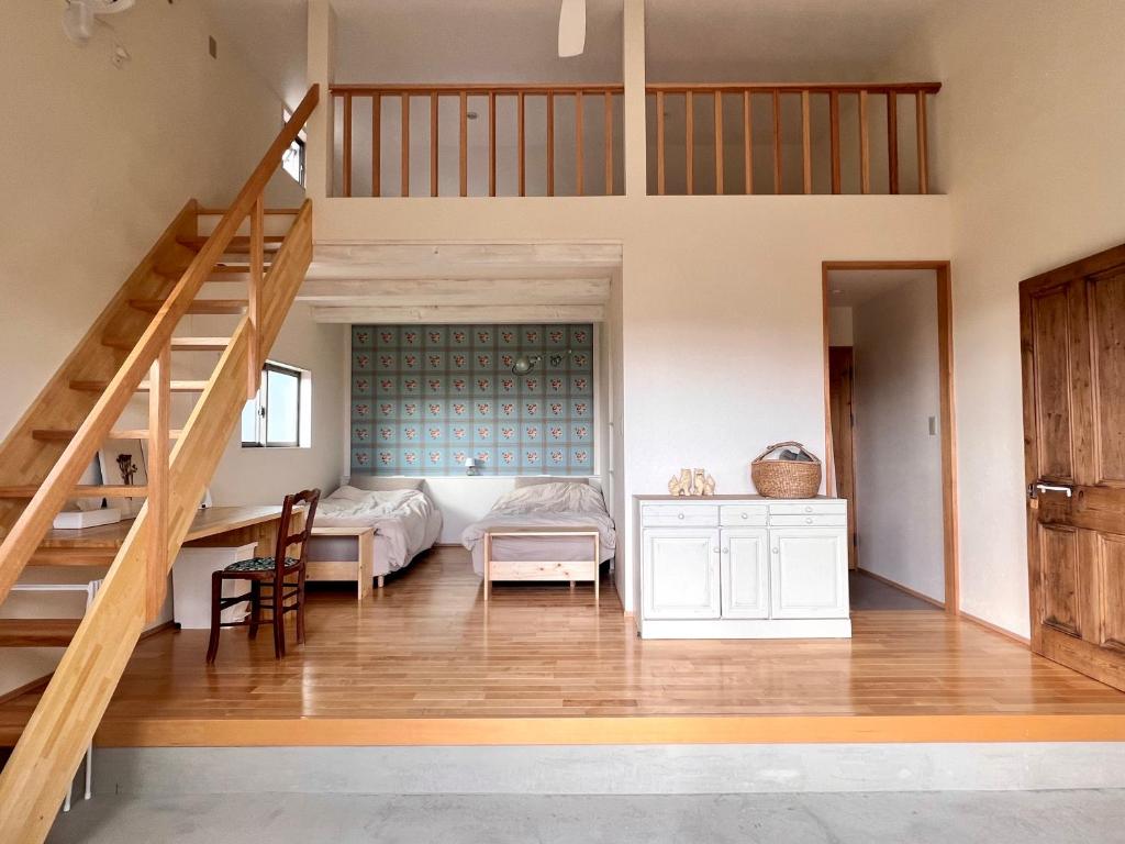 a bedroom with a bunk bed and a staircase at yucurum in Itoman