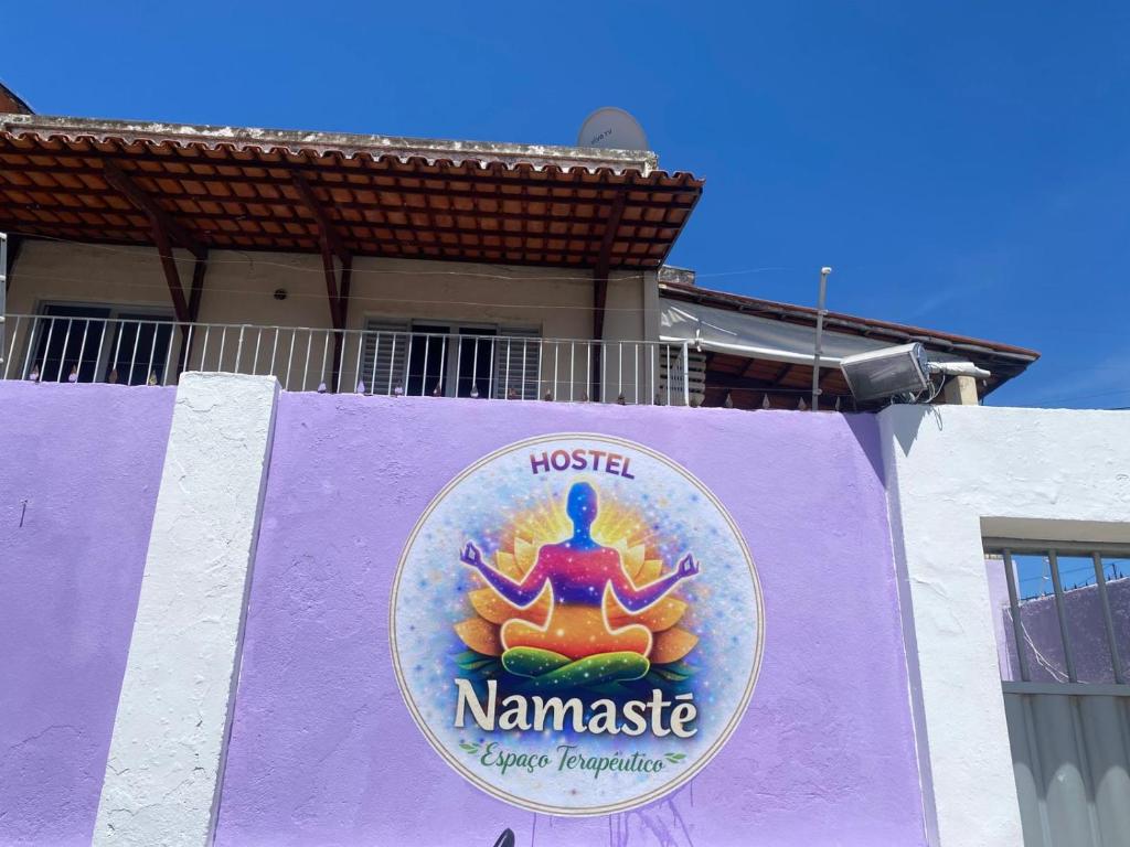 a purple sign on the side of a building at Hostel Namastê in Maceió