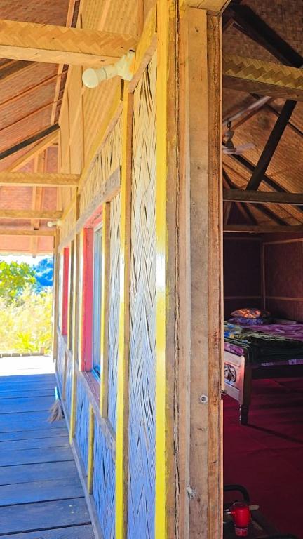 a room with yellow and blue paint on the wall at Nature's Harmony Heaven Resort in Dāmbuk