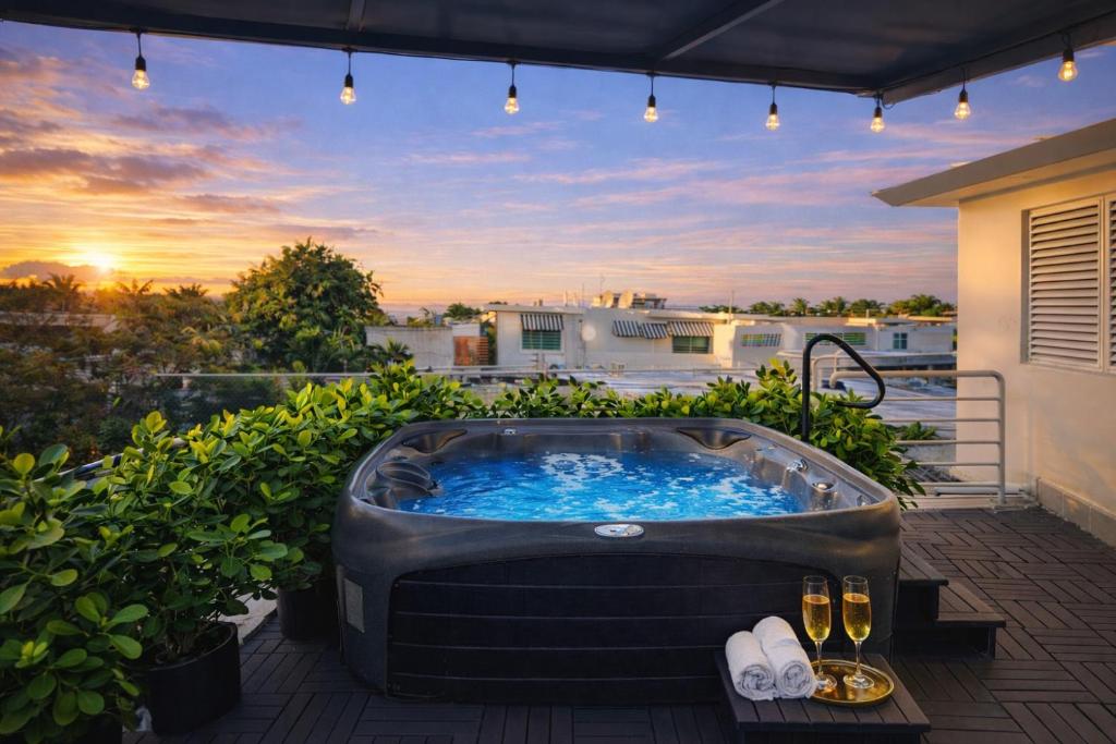a hot tub on a patio with a sunset at Ocean Park 3BDR 2b Hot tub-Terrace Riviera Villa in San Juan