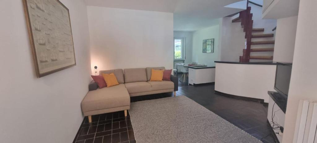a living room with a couch and a table at Villa I Cigni Holidays Home in Arona