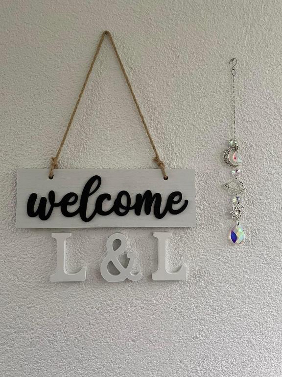 a welcome sign hanging on a wall at L&L in Sarajevo