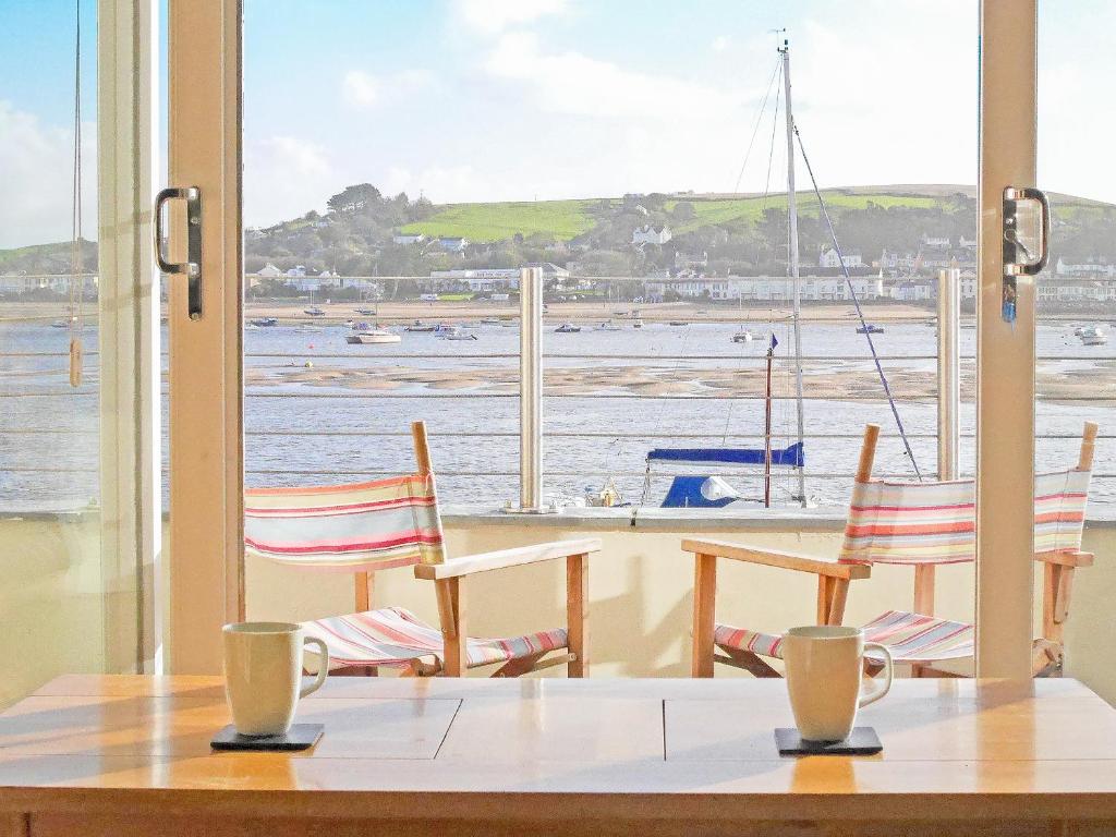 a table with chairs and a view of the water at Shorewaters in Appledore